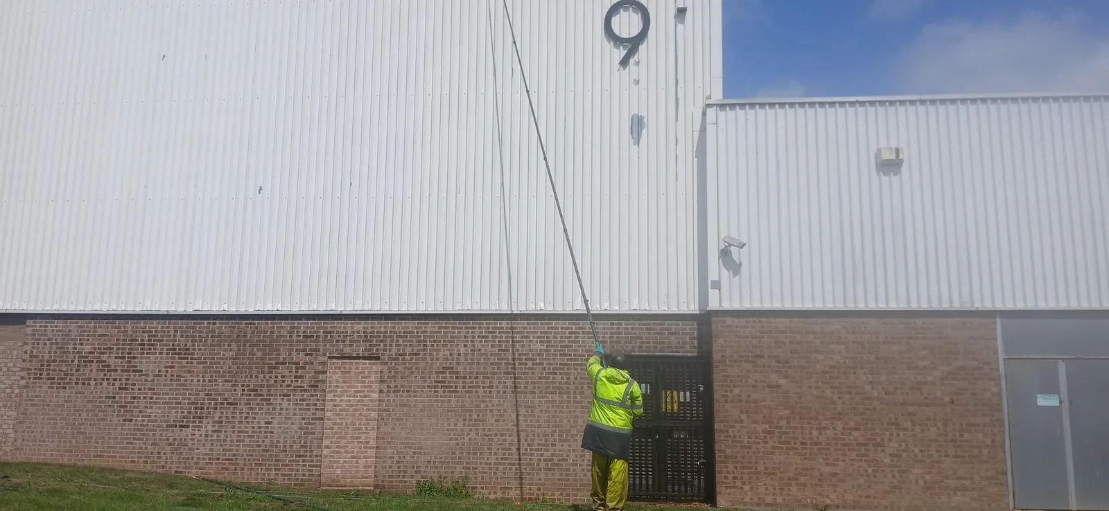 AJB Group warehouse cladding cleaning in progress - wide angle, Corby