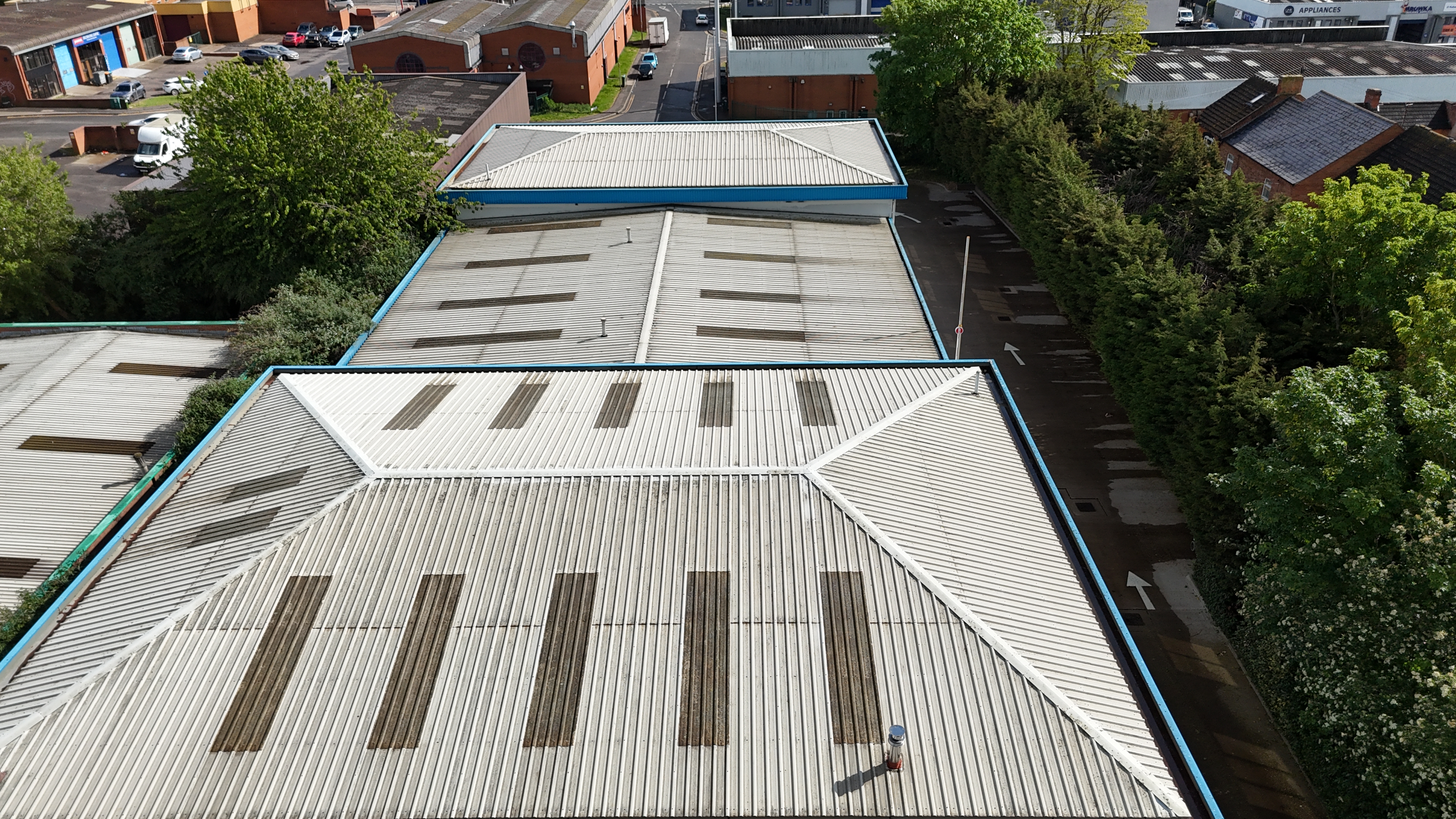Aerial drone view of commercial roof zones, gutter lines and skylights on an industrial estate in Northampton