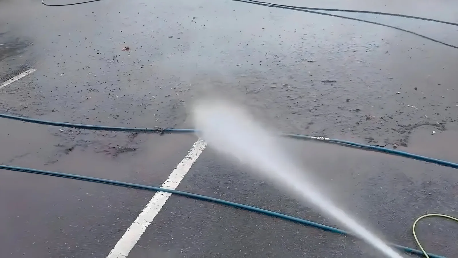 Pressure washing tarmac surface with industrial lance
