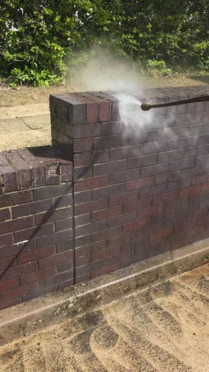 commercial red brick wall pressure washed algae removal