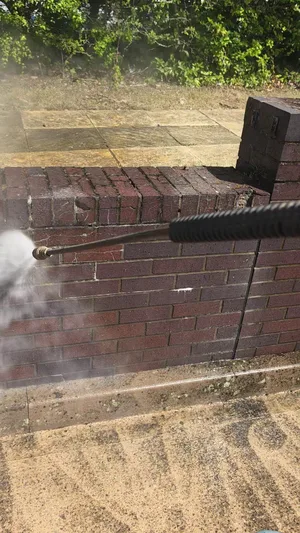 During - commercial red brick boundary wall pressure washed algae removal, Rugby.
