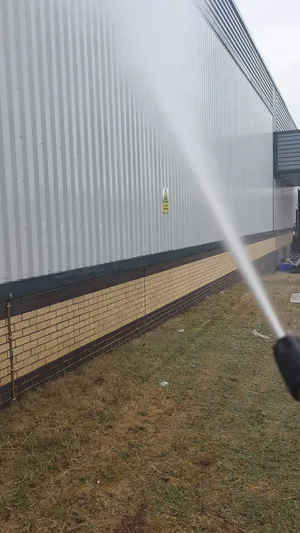 commercial building metal cladding pressure washed algae removal