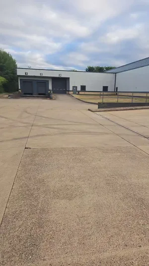 commercial warehouse concrete yard loading bay soiling before clean