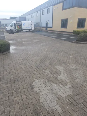 Before - commercial car park block paving heavy algae staining before clean, Rugby.