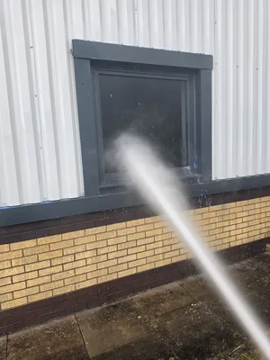 During - commercial building metal roof rooflight frame pressure washed, Rugby.
