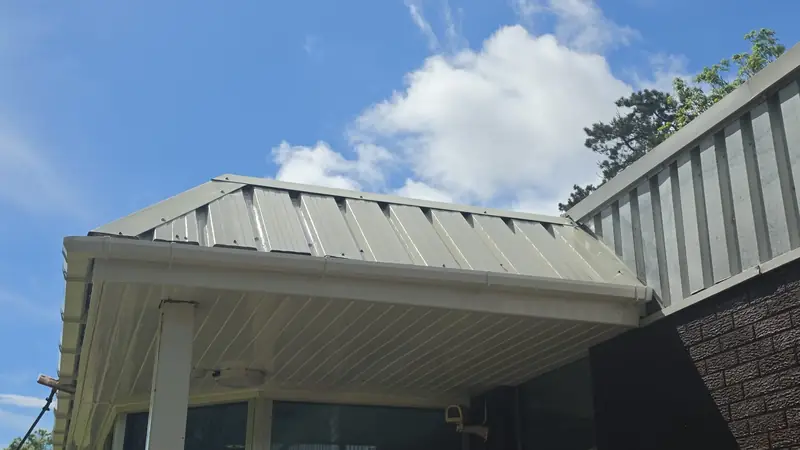 Entrance canopy cladding after clean cream white, Northampton.