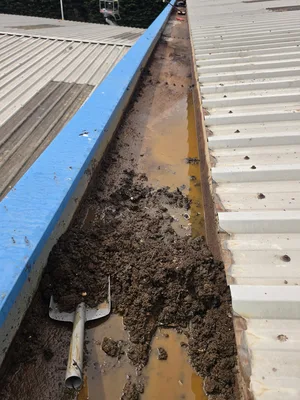 commercial metal box gutter manual debris clearance heavy silt rust