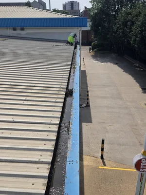 During - commercial metal cladding box gutter manual debris clearance heavy organic growth, Northampton.