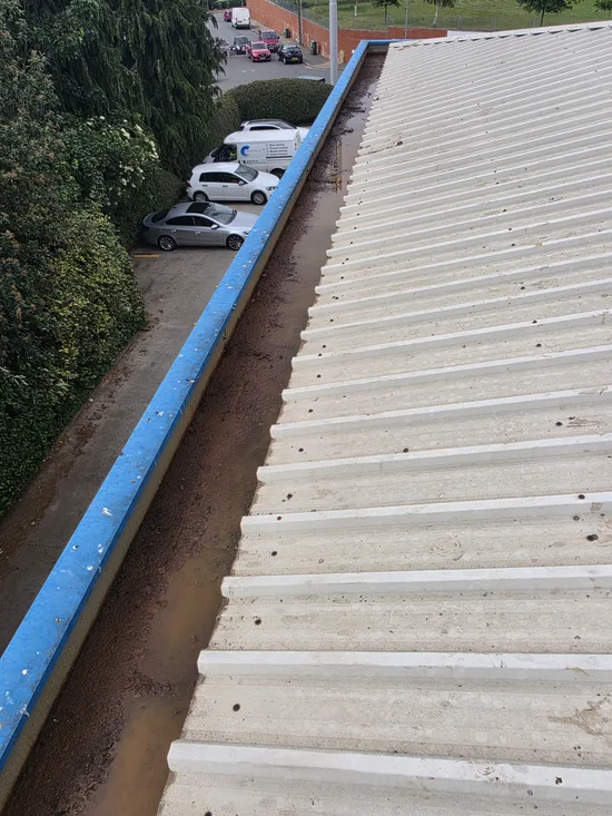 Before - commercial building box gutter heavy debris moss blockage, Northampton.