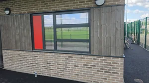 After - commercial school building timber cladding buff brick window clean, West-Bromwich.