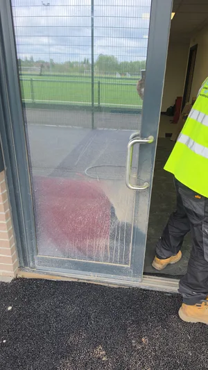 Before - commercial school glass door panel red algae heavy soiling, West-Bromwich.