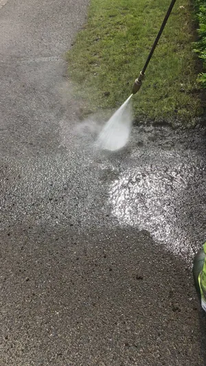 During - tarmac driveway algae staining pressure washed mid clean, Orlingbury.
