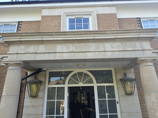 residential stone portico columns algae staining biological growth