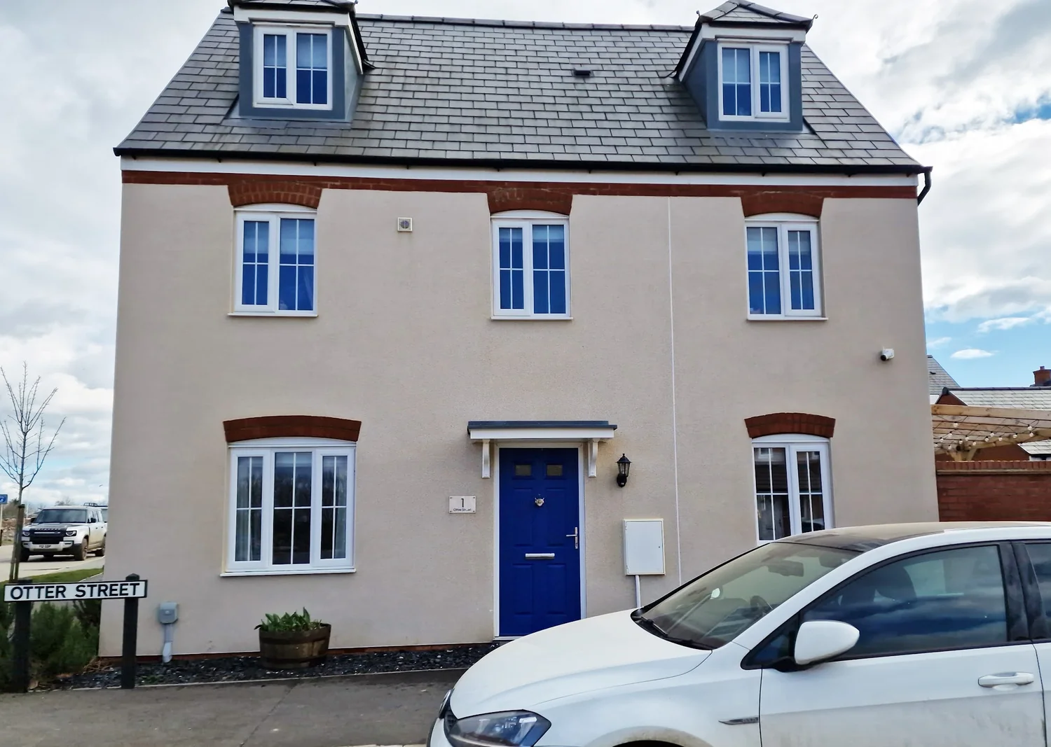 Residential render cleaning on a detached house showing clean K-Rend finish