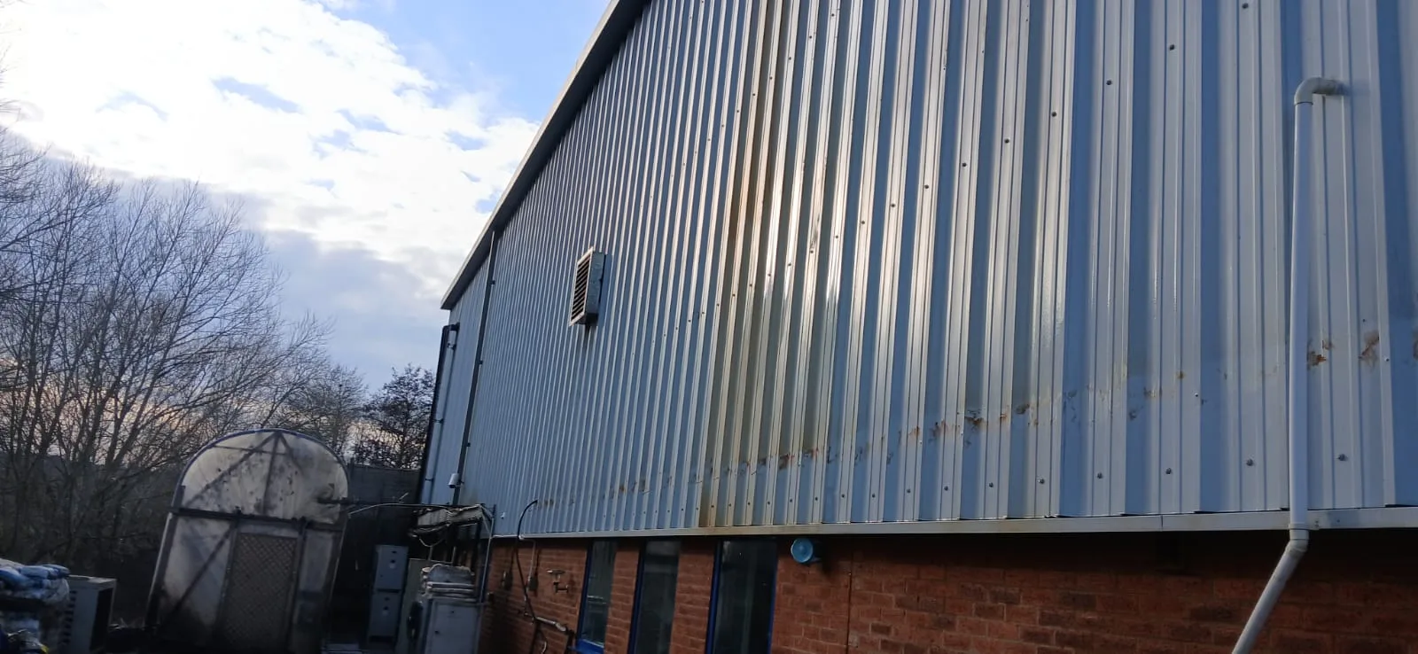 Lung Wah Chong warehouse cladding showing weathering and algae before cleaning, Oxford OX2