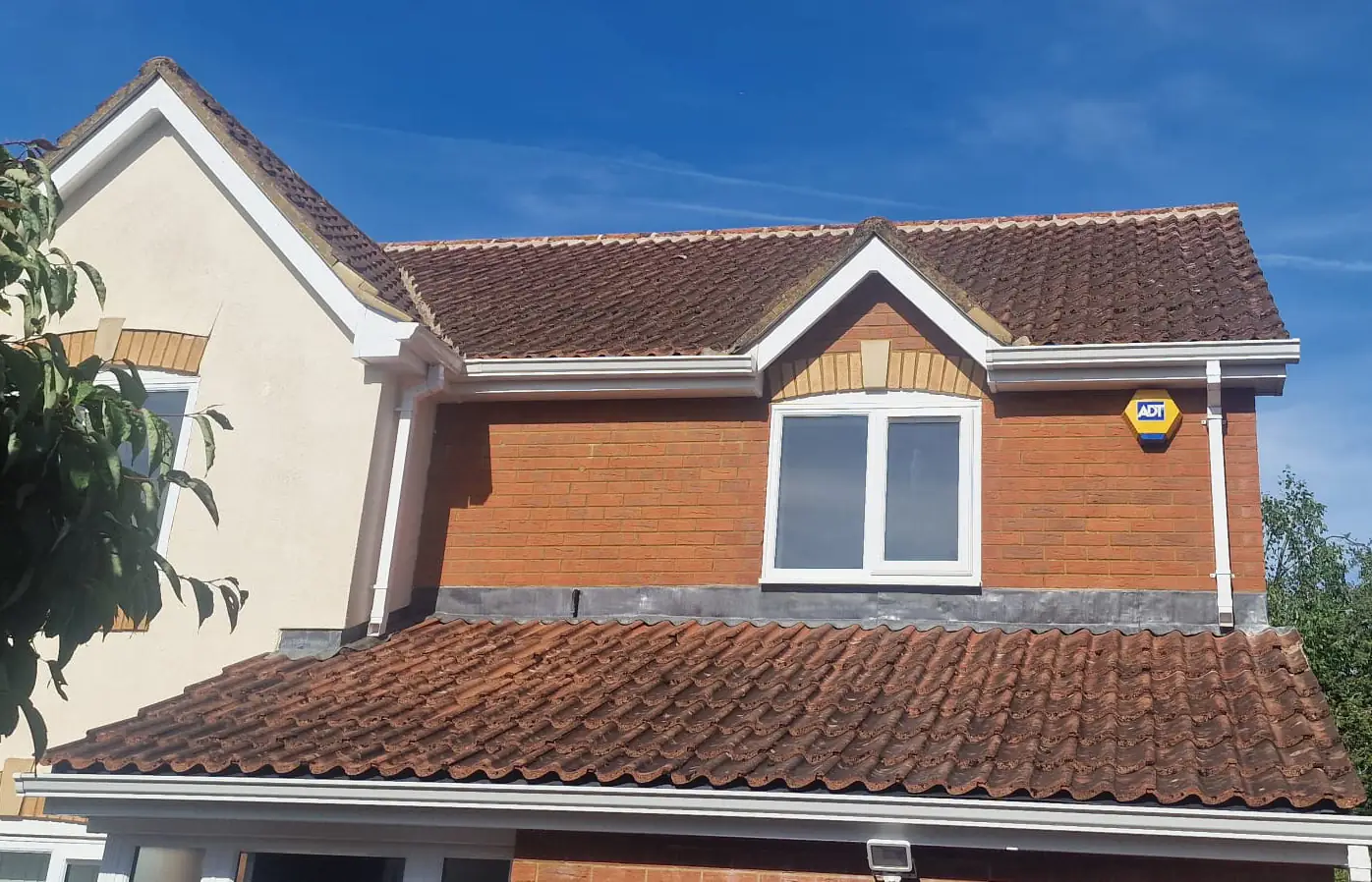Applying DDAC biocide treatment to a freshly cleaned roof for 4-5 year protection