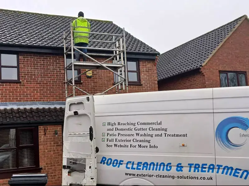 ECS branded van and operative on a scaffold tower on a roof cleaning job